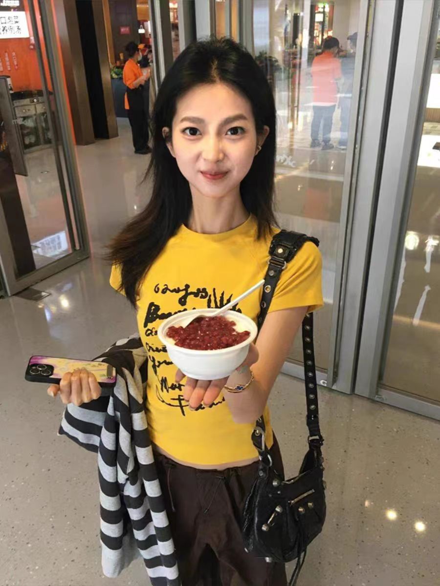 Yellow Off-Shoulder T-Shirt for Women - Graffiti Print, Short Sleeves, Slim Fit, Summer Sweet and Spicy Style Yellow Off-Shoulder T-Shirt for Women - Graffiti Print, Short Sleeves, Slim Fit, Summer Sweet and Spicy Style