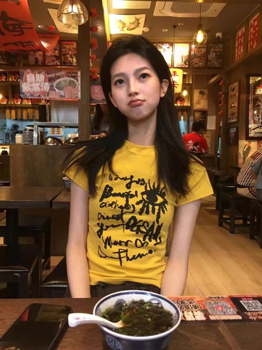 Yellow Off-Shoulder T-Shirt for Women - Graffiti Print, Short Sleeves, Slim Fit, Summer Sweet and Spicy Style Yellow Off-Shoulder T-Shirt for Women - Graffiti Print, Short Sleeves, Slim Fit, Summer Sweet and Spicy Style