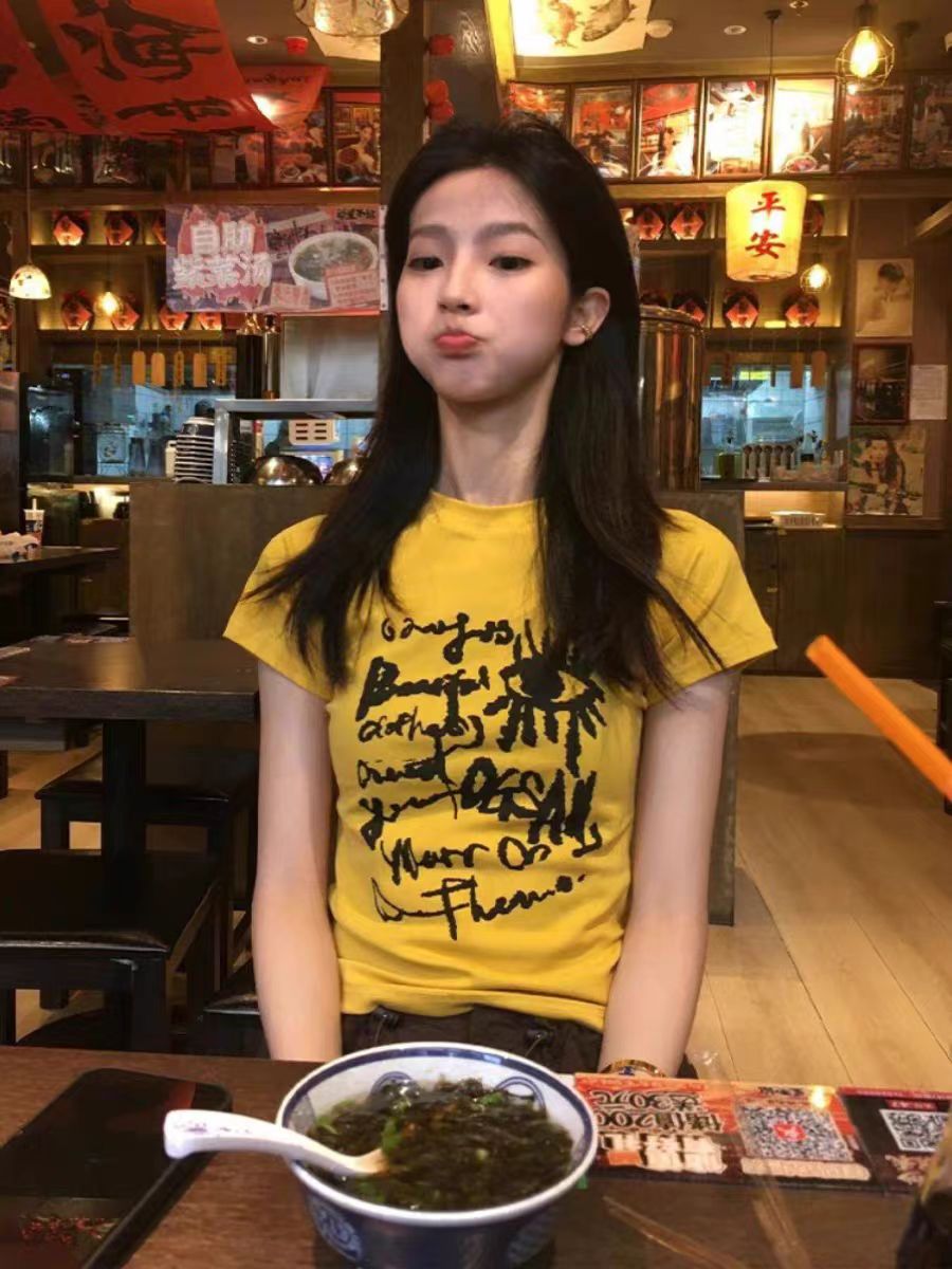 Yellow Off-Shoulder T-Shirt for Women - Graffiti Print, Short Sleeves, Slim Fit, Summer Sweet and Spicy Style Yellow Off-Shoulder T-Shirt for Women - Graffiti Print, Short Sleeves, Slim Fit, Summer Sweet and Spicy Style