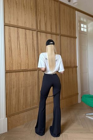 Rase le sol High-Waisted Stretch Flared Pants with Asymmetric Wrap Tie Detail